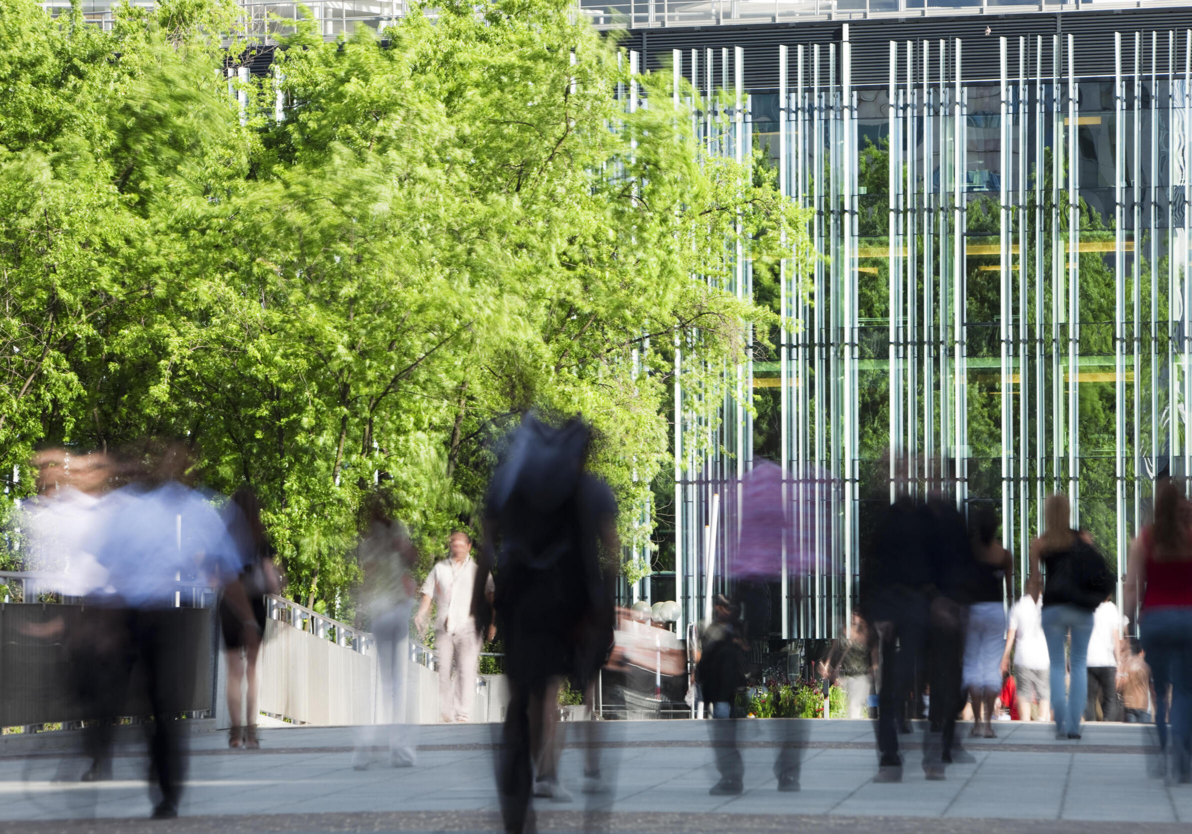 blurred business people walking to work, long exposure, focus on background